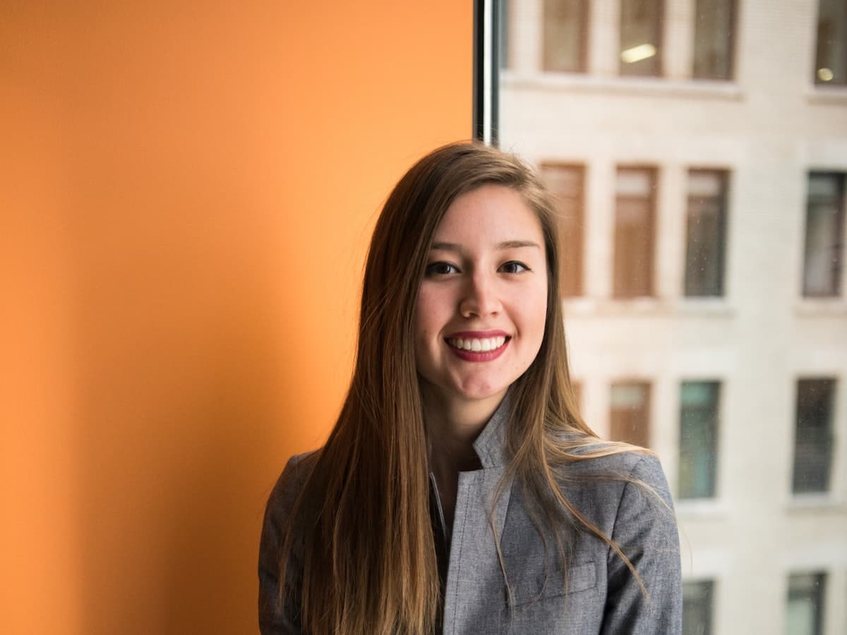 A professional real estate agent smiling, representing their digital showroom